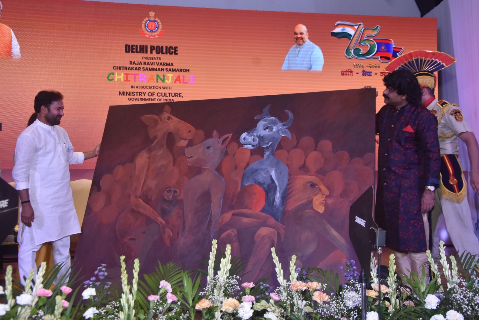 A painting being unveiled on stage at Chitranjali
