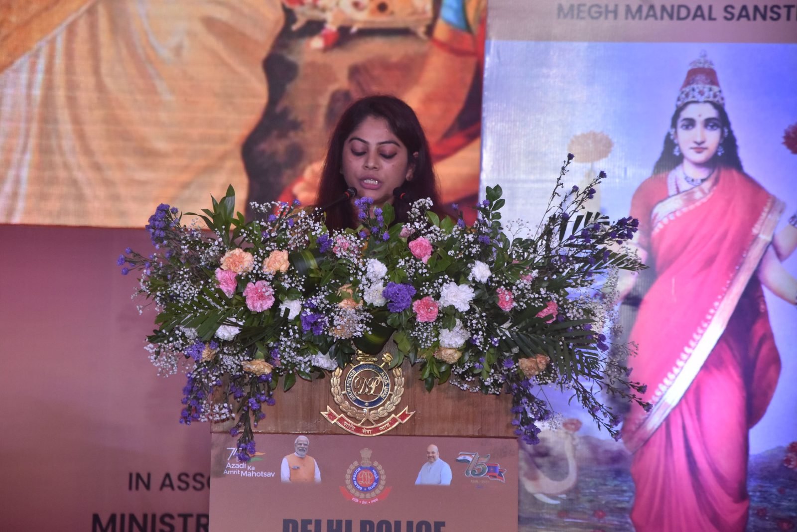 Secretary Vimlesh Brijwall speaking at the podium at Chitranjali