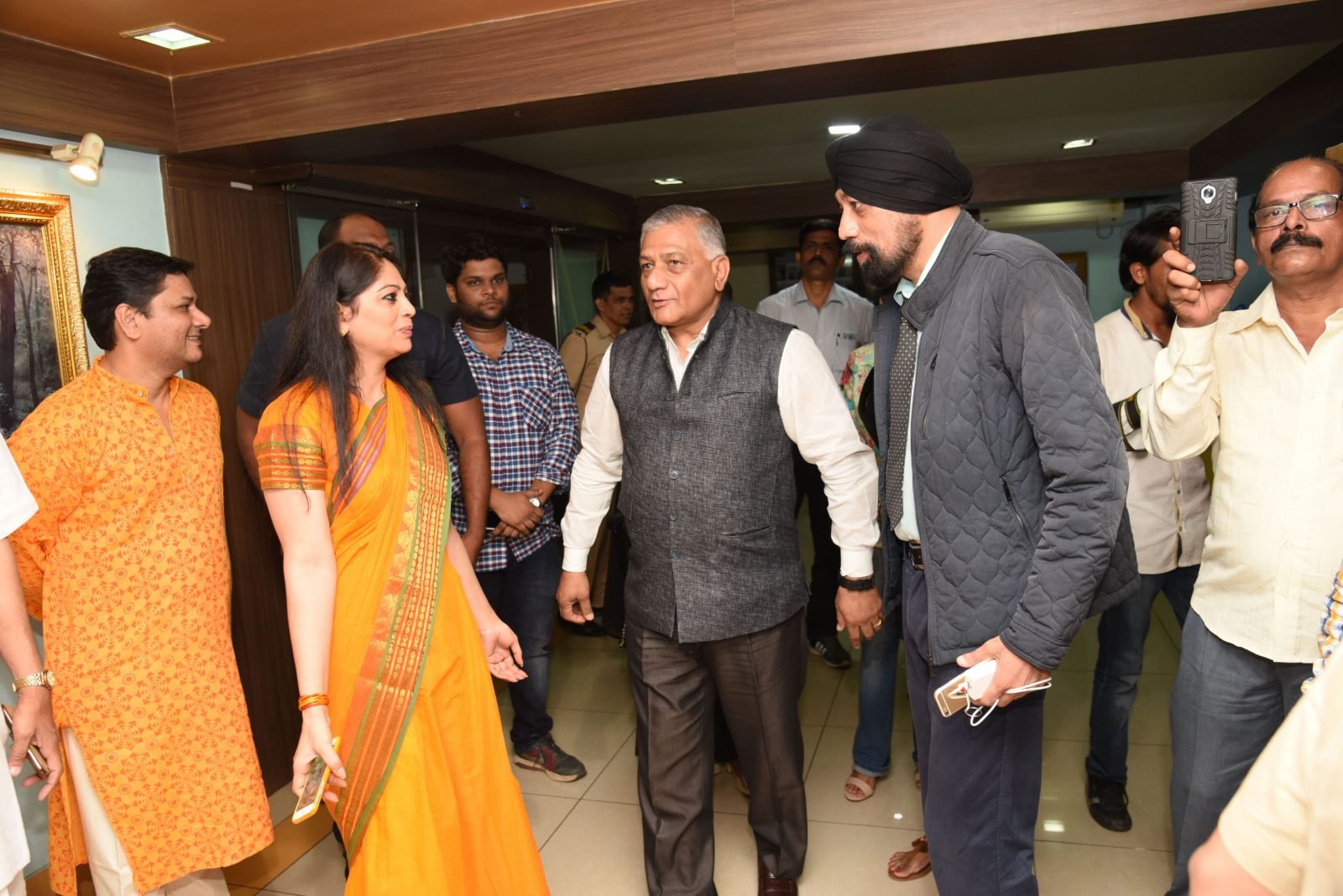 General (Dr.) V. K. Singh arriving through the foyer with the Secretary
