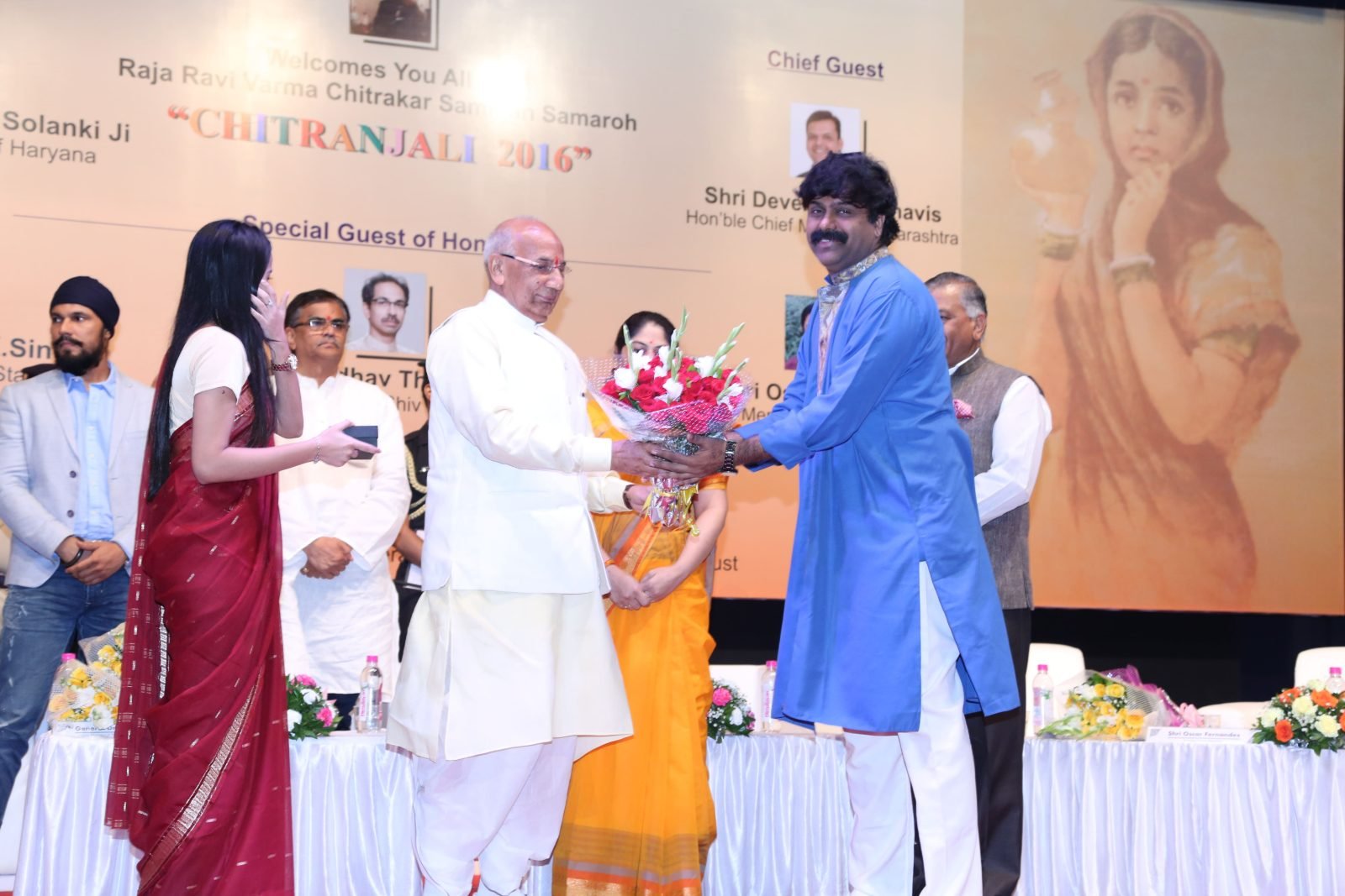 A bouquet being presented to the Chief Guest on stage at Chitranjali 2016