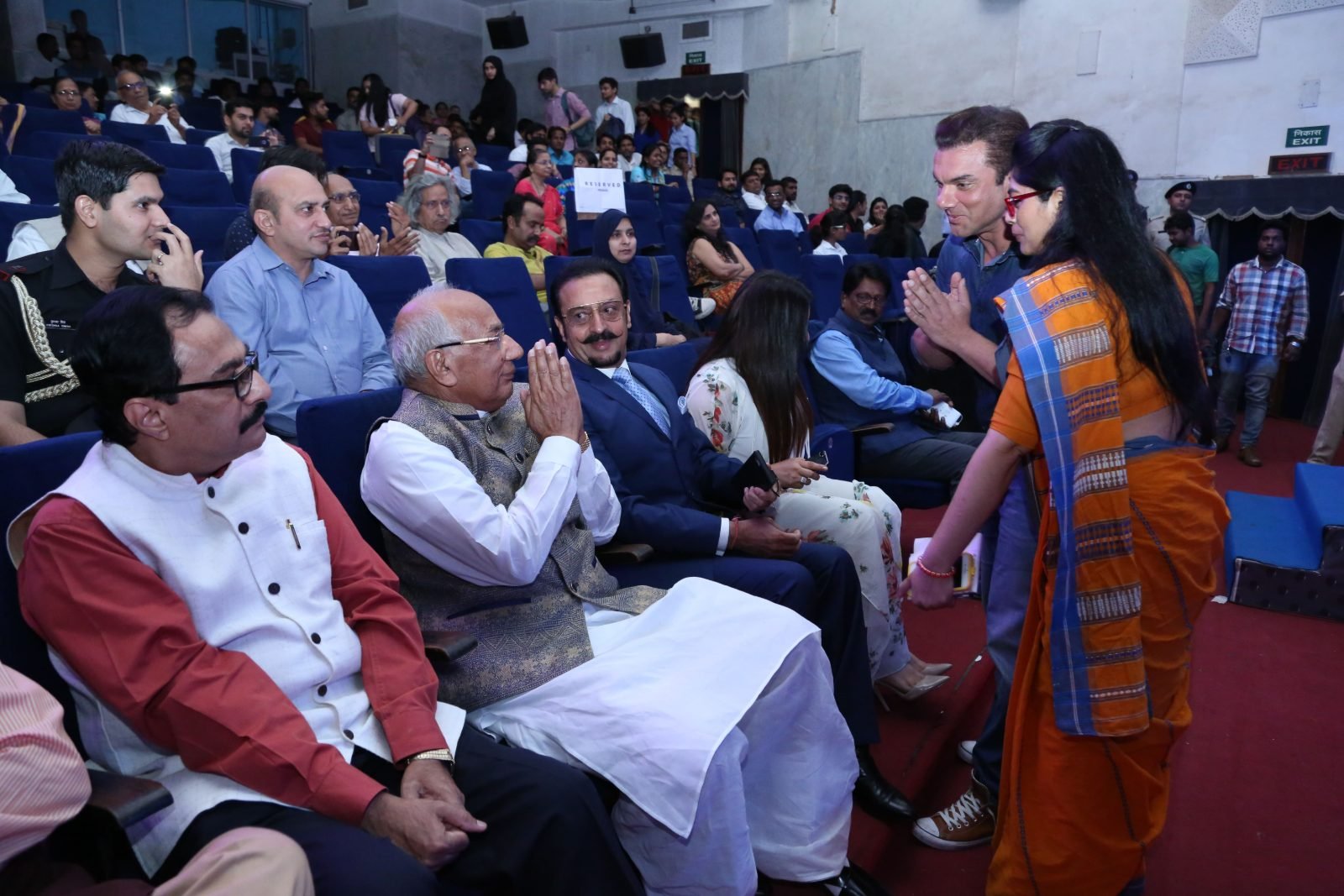 Guests of honour greeted in the auditorium before the ceremony