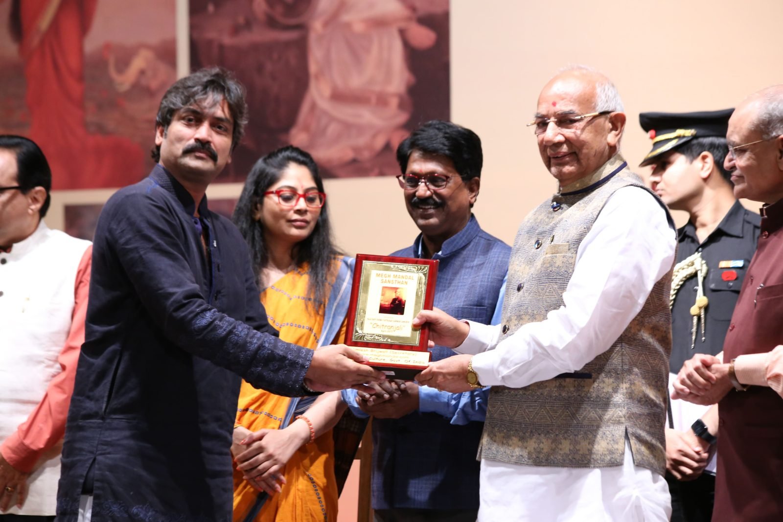 An honoured artist receiving a plaque at Chitranjali 2017