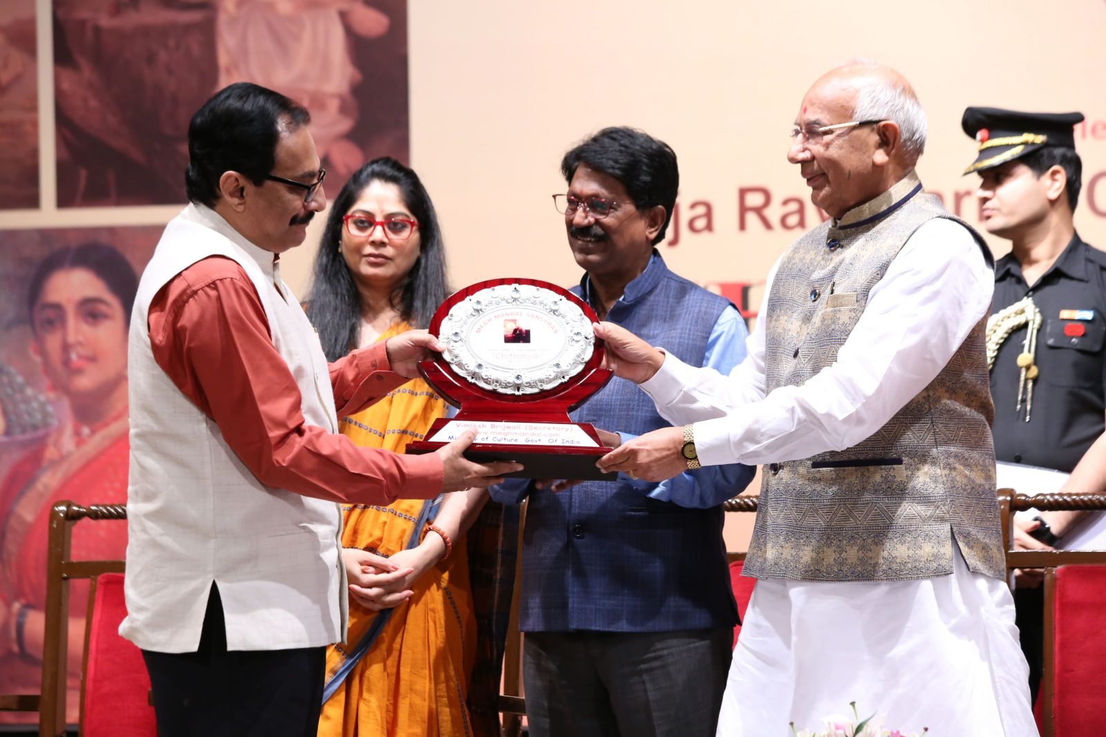 An awardee receiving a silver plate from the Governor at Chitranjali 2017