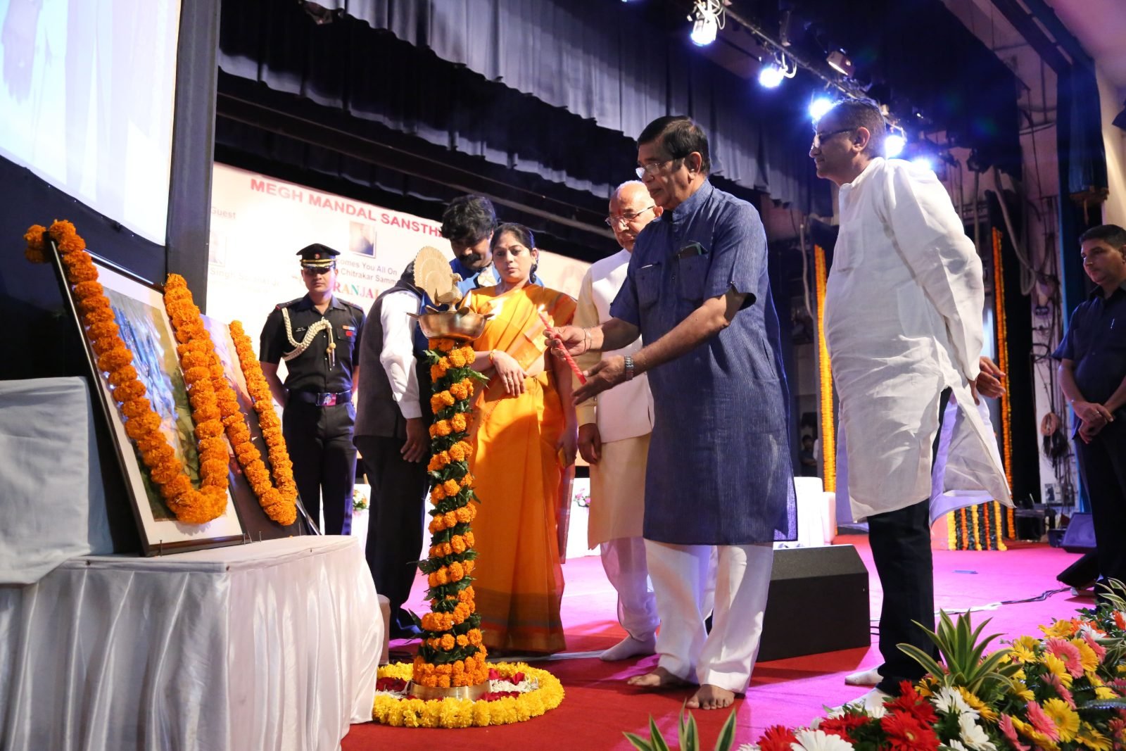 A guest of honour lighting the ceremonial lamp at Chitranjali